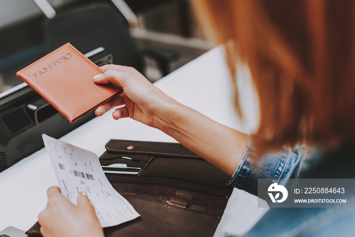 Young tourist is giving boarding pass to check-in officer