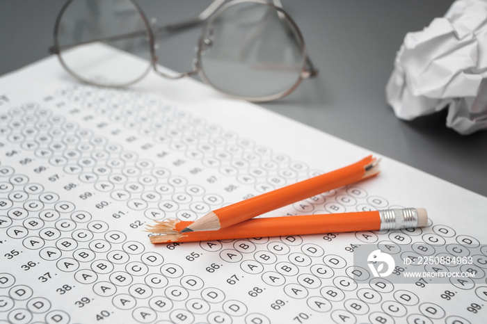 Broken pencil and test sheet on table, closeup. Preparation for exam