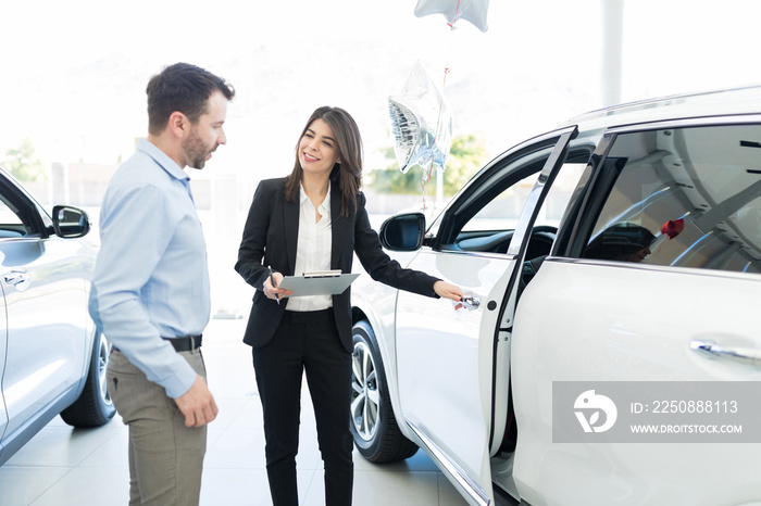 Confident Seller Displaying Features Of Car Proudly