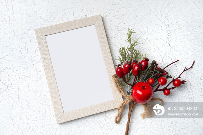 Christmas winter composition. Blank frame mockup and winter red branch. View above.