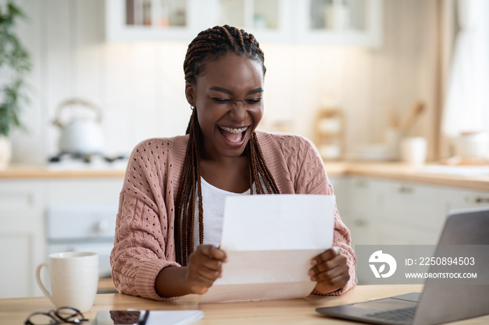 Overjoyed Black Woman Reading Letter In Kitchen And Exclaiming With Excitement