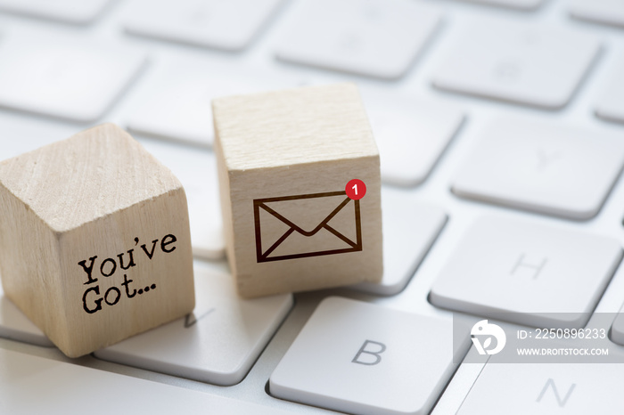 You’ve got mail message on wooden cubes with computer keyboard and e-mail icon suggesting unread mes