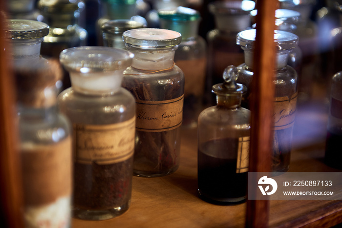 Old bottles with herbs and medicines in the pharmacy