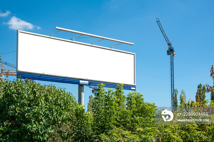 Huge blank white billboard for advertisement near construction site