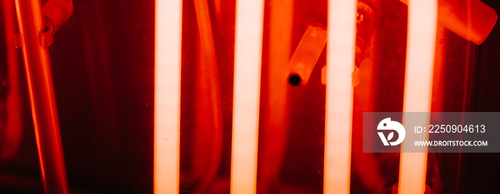 Abstract neon pipes in red color. Part of a neon sign