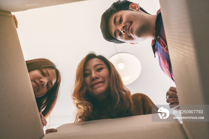 Group of young people opening and looking for a gift in the box