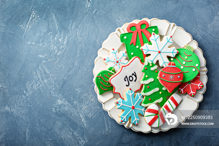 Christmas sugar and gingerbread cookies decorated with royal icing on a plate overhead