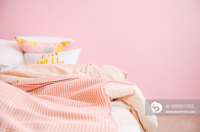 Pink pastel wall tone bedroom, cozy pink bed and pillow