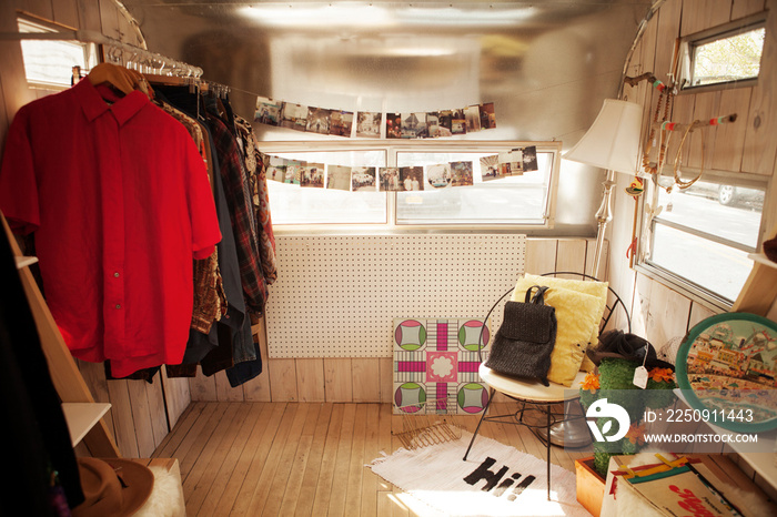 Cozy room with clothe rack, chair and floor lamp,