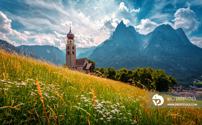 Summer mountain scenery in Dolomites. Wonderful sunny landscape. San Valentino Church in Castelrotto