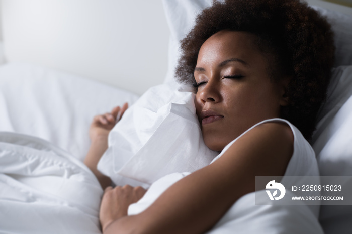 Woman sleeping in her bed