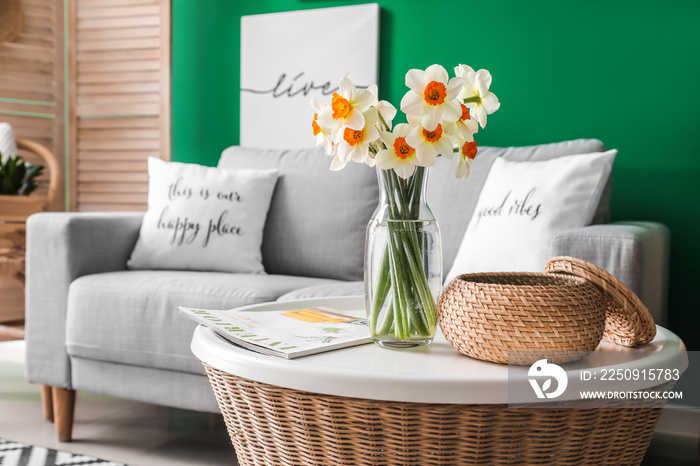 Beautiful spring flowers on table in interior of living room