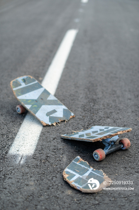 Broken skateboard on the street.