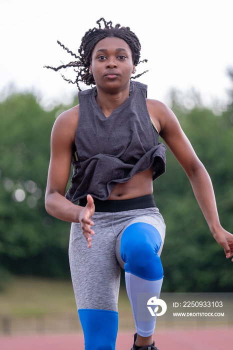 Athletic�woman running on track