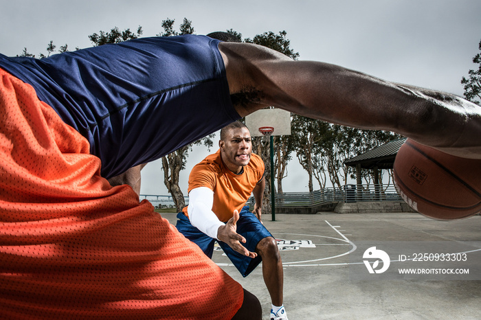 Young basketball players playing on court, close up