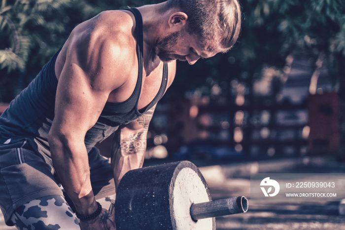 Cute young European man doing strength fitness workout, healthy lifestyle sport concept, weight lift