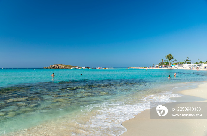 The most famous beach of Cyprus with crystal clear water. Nissi Beach.