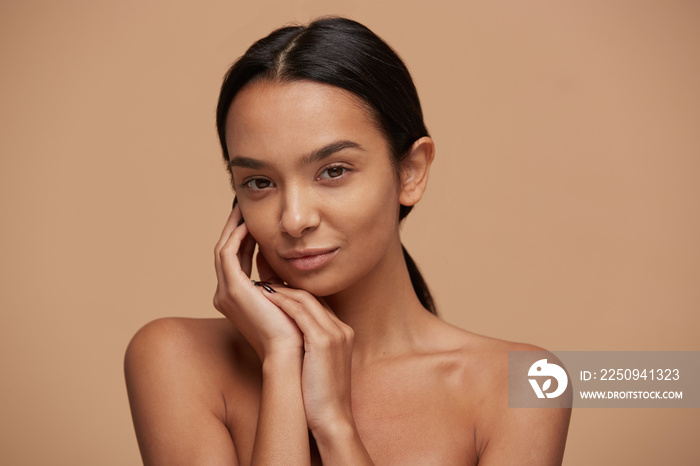 Head shot of an attractive mixed race girl, looking gently and tenderly, demonstrates healthy beauti