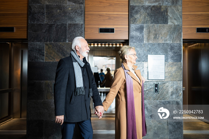 Two married adults walking together hand in hand