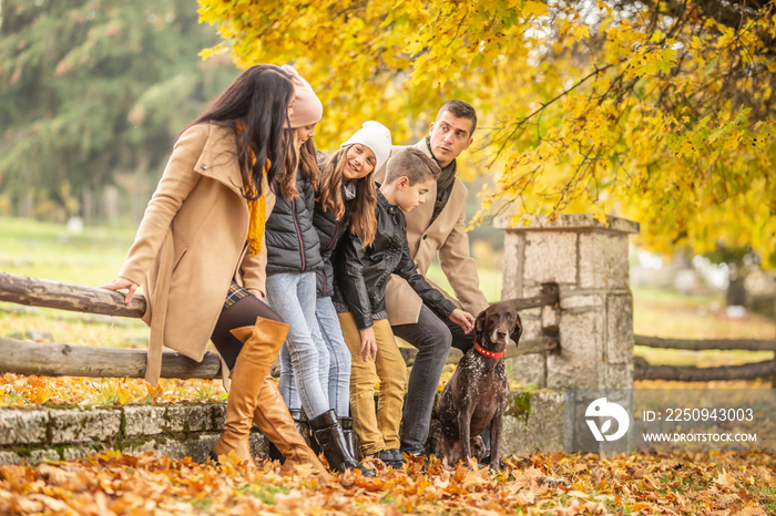 A family talks and enjoys moments outdoors during a colorful fall day