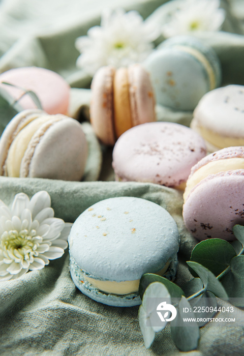 Beautiful colorful tasty macaroons on a textile background