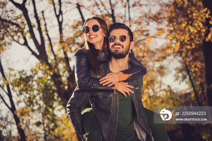 Photo of positive couple guy hold piggyback his beautiful girlfriend in september city forest park w