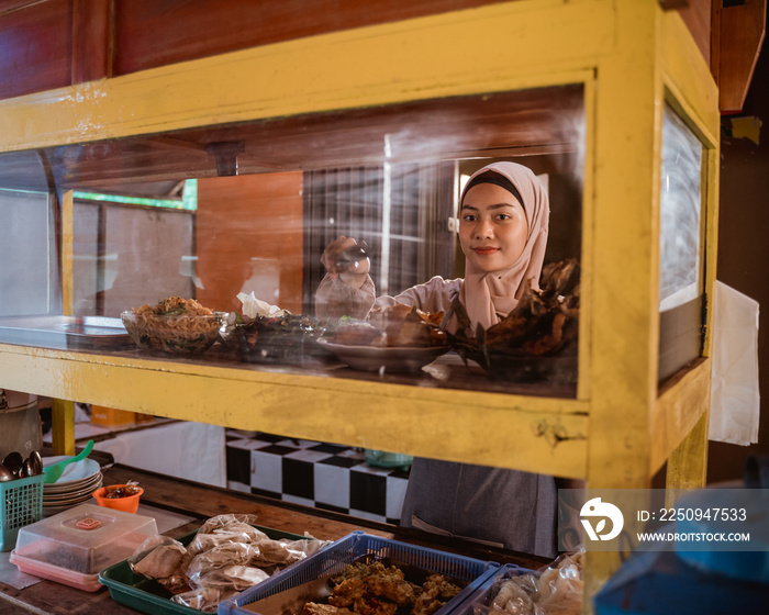 muslim asian woman preparing her food stall