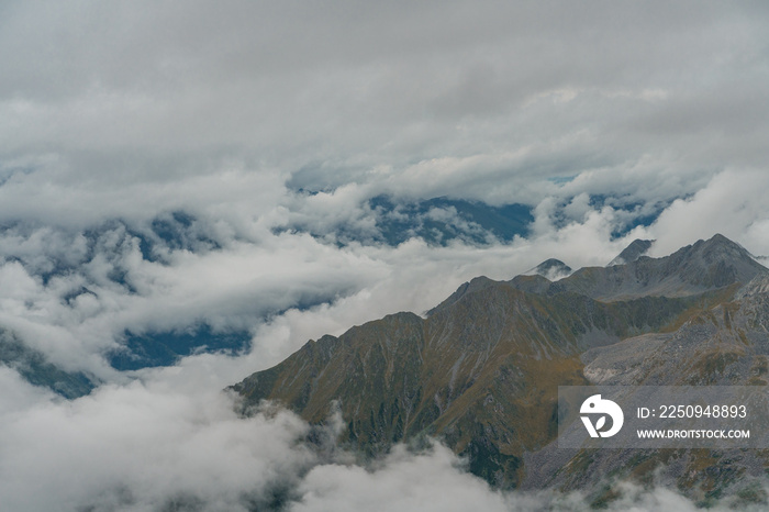 The mountain landscape with clouds around in Dagu glacier park in Sichuan, China.