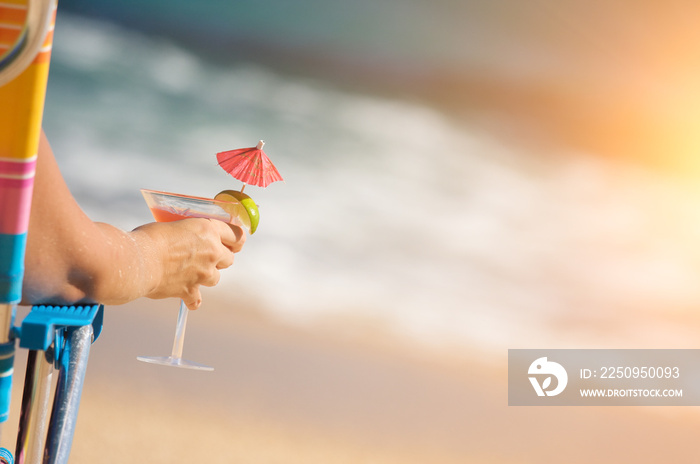 Woman Relaxing on Beach with Tropical Drink.