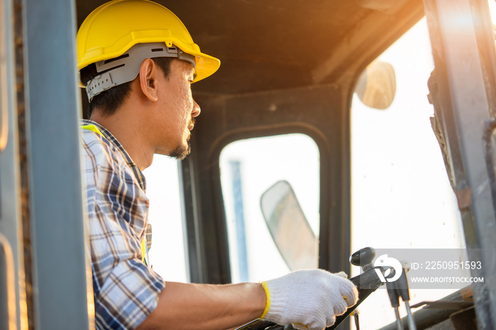 Engineer or architect with white helmet driving Loader Truck at construction site,Engineering Constr