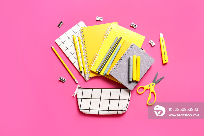 Pencil case with stationery on color background