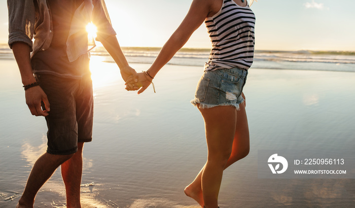 Loving couple strolling on the shore