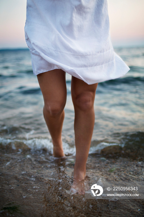 Low section of woman standing in water