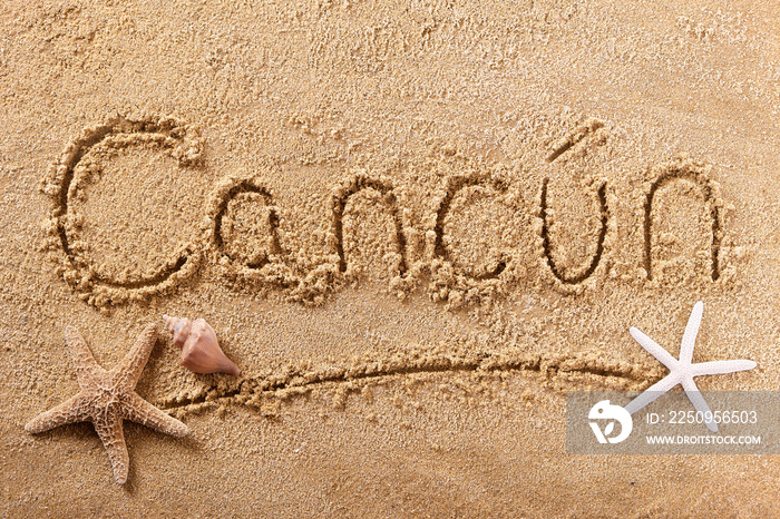 Cancun mexico word written in sand sign writing drawing drawn on a sunny mexican summer beach with s