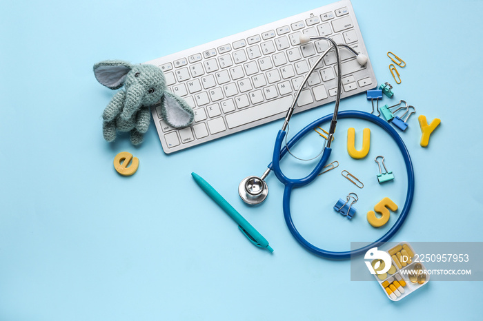 Composition with PC keyboard, stethoscope and toy on color background