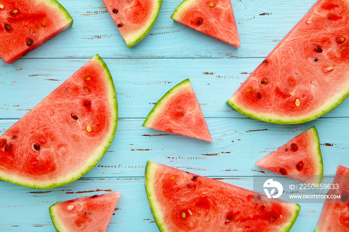 Slices watermelon on the blue color wooden background.