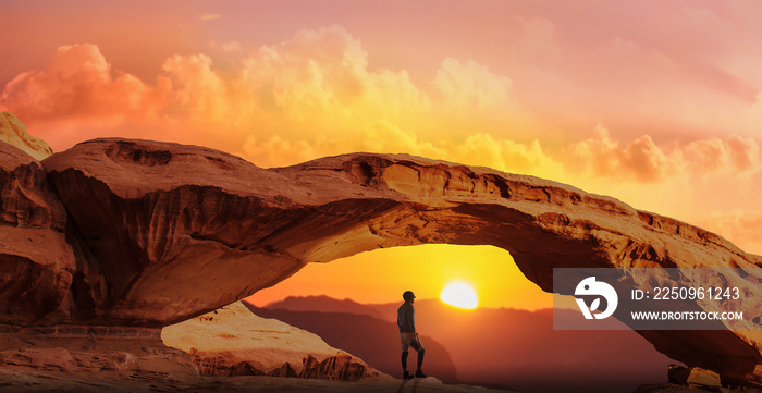 men exploring the natural desert arch and enjoy at evening sunset.copy space 