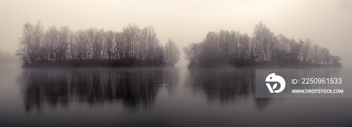 wooded islets in a lagoon at dawn