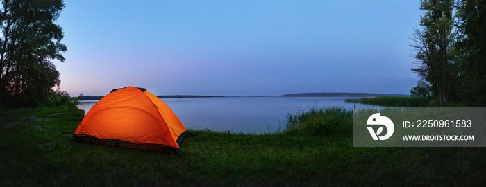 Orange tent by the lake