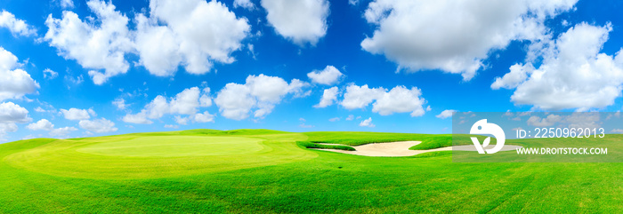 Green golf course and blue sky with white clouds,panoramic view.