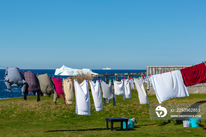 Iconic tourism day in Newfoundland and Labrador with clothes on the line and icebergs in the backgro