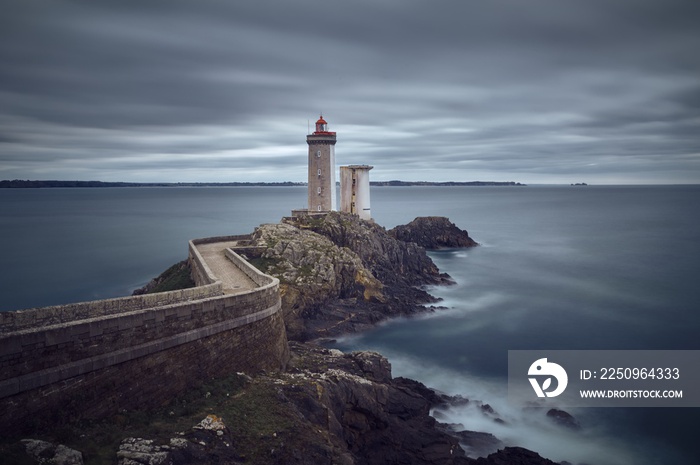 Petit Minou Lighthouse in France with a beautiful view of an ocean under a cloudy gray sky