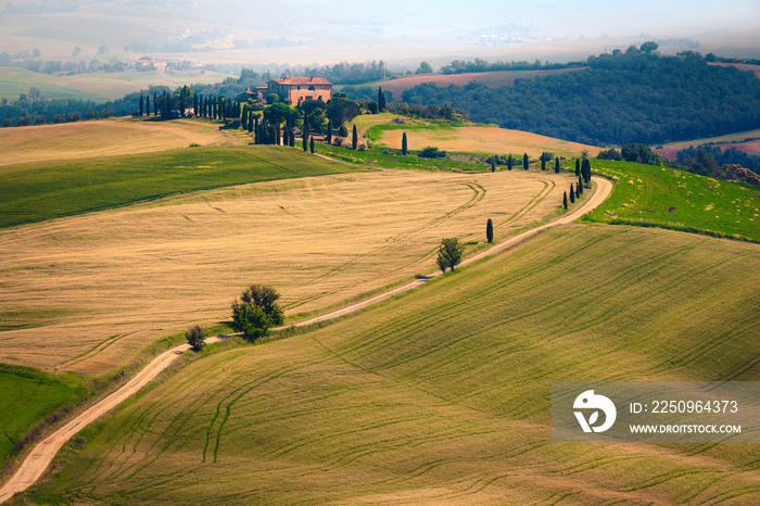 Admirable misty Tuscany landscape with rural curved road, Italy