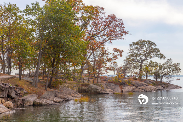 The Manor park of Larchmont on a autumn landscape with calm ocean water