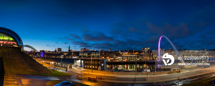 Newcastle Quayside Panorama at night, on the banks of the River Tyne, with its famous bridges and Ne