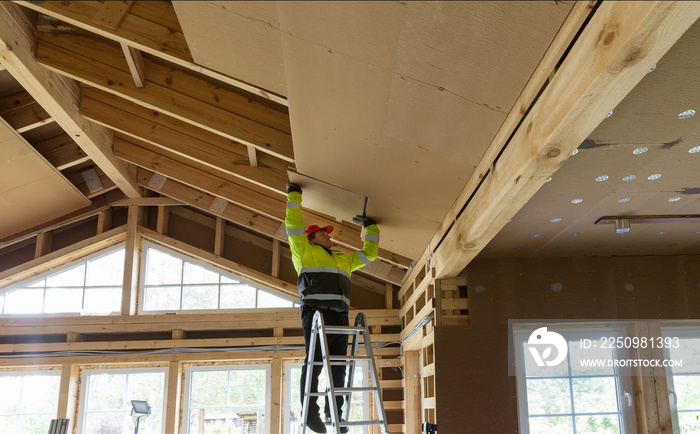 Construction worker thermally insulating eco wooden frame house