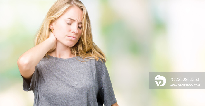 Beautiful young woman wearing oversize casual t-shirt over isolated background Suffering of neck ach