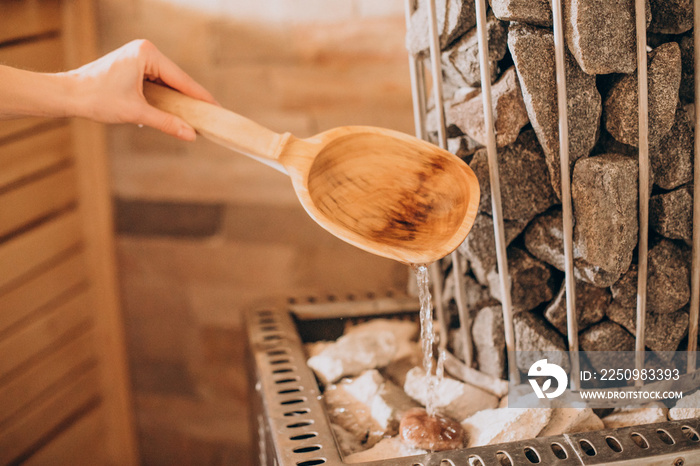 Spoon with cold water in sauna