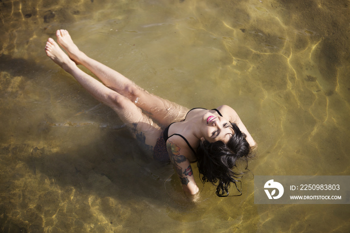 Overhead view of woman sitting in water