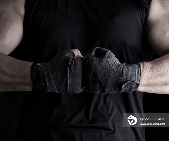 two mens hands wrapped in a black bandage